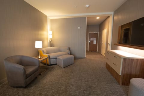 Suite, 2 Queen Beds | Living area | 55-inch flat-screen TV with cable channels, TV, pay movies