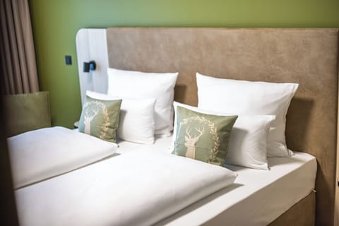 Hypo-allergenic bedding, desk, laptop workspace, blackout drapes