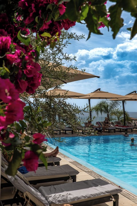 Seasonal outdoor pool, open 8:00 AM to 8:00 PM, pool umbrellas