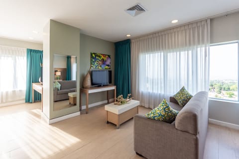 Suite, 1 King Bed, Refrigerator, Garden View | Living room | Flat-screen TV