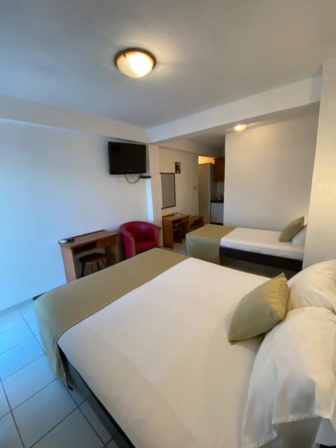 Standard Triple Room, Sea View | Minibar, in-room safe, desk, iron/ironing board