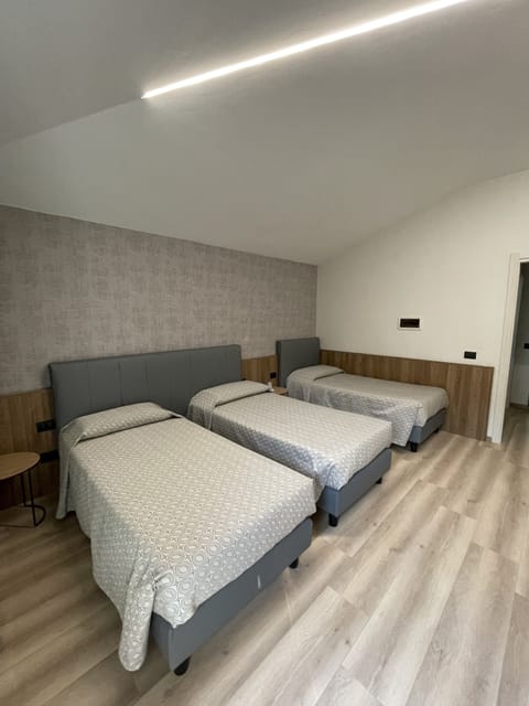 Triple Room | Minibar, in-room safe, desk, soundproofing