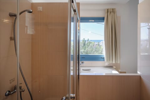 Family Deluxe Suite, Jetted Tub, Sea View | Bathroom | Designer toiletries, hair dryer, bathrobes, slippers