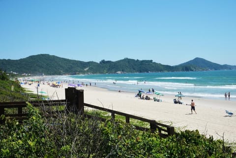 On the beach, white sand, sun loungers, beach umbrellas