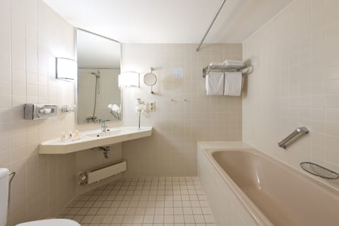 Bathtub, eco-friendly toiletries, hair dryer, towels