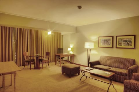 Executive Suite | Living room | 42-inch plasma TV with cable channels, TV, iPod dock