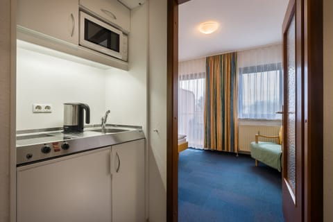 Standard Apartment, 1 Twin Bed | Private kitchen | Fridge, microwave, stovetop, coffee/tea maker