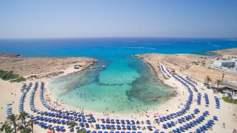 On the beach, white sand, sun loungers, beach umbrellas