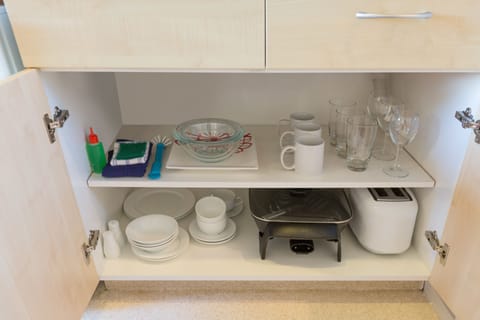 Fridge, microwave, coffee/tea maker, cookware/dishes/utensils