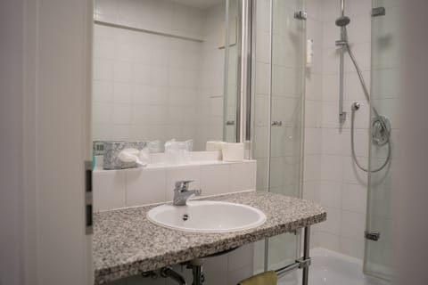 Standard Studio | Bathroom | Shower, hair dryer, soap, shampoo