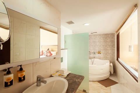 Suite Room | Bathroom | Rainfall showerhead, designer toiletries, hair dryer, slippers