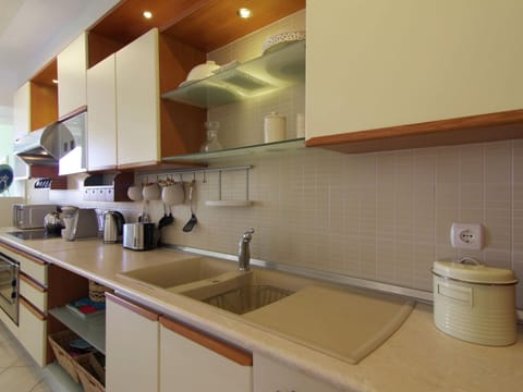 Villa | Private kitchen | Stovetop, highchair, dining tables