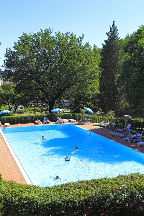 Seasonal outdoor pool, open 10:00 AM to 7:00 PM, pool umbrellas