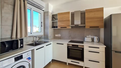 Luxury Apartment | Private kitchen | Fridge, electric kettle, highchair, cookware/dishes/utensils