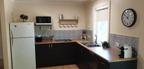 Donnybrook Cottage | Private kitchen | Full-size fridge, stovetop, dishwasher, coffee/tea maker