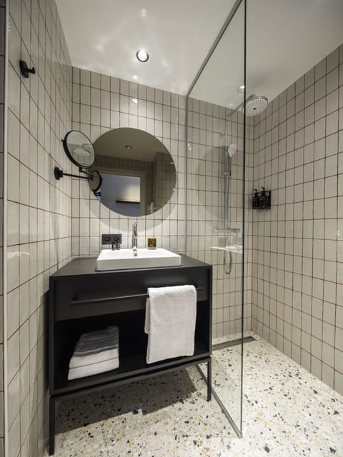 Not-so-Standard room with a view | Bathroom | Shower, rainfall showerhead, hair dryer, towels