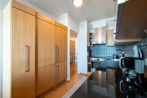 Deluxe Penthouse | Private kitchen | Full-size fridge, microwave, oven, coffee/tea maker