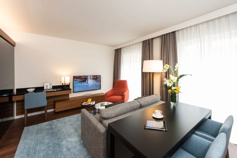 Deluxe Suite | Living area | 75-cm LED TV with satellite channels, TV, heated floors