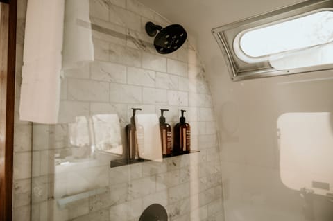 Shower, rainfall showerhead, hair dryer, towels