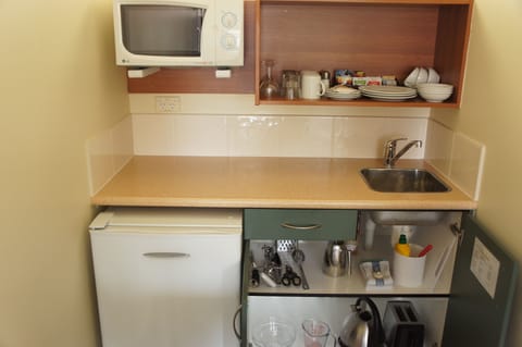 Fridge, microwave, coffee/tea maker, cookware/dishes/utensils