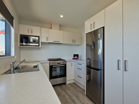 Two Bedroom Apartment | Private kitchen | Fridge, microwave