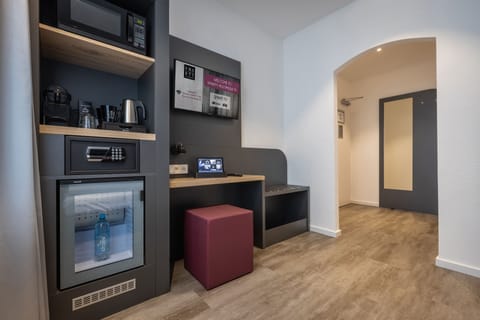 Compact Double Room | Living area | 32-inch flat-screen TV with cable channels, TV, tablet