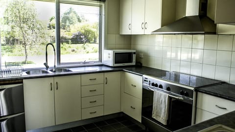 Mc Namara Four Bedroom Cottage | Private kitchen | Full-size fridge, microwave, oven, stovetop