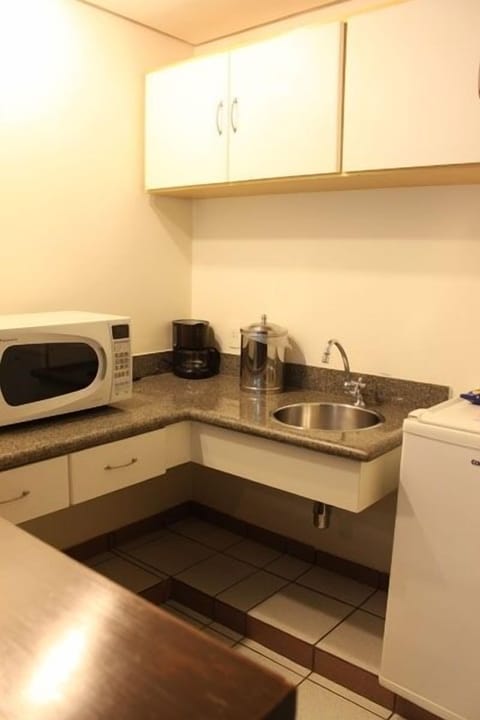 Fridge, microwave, coffee/tea maker, cookware/dishes/utensils