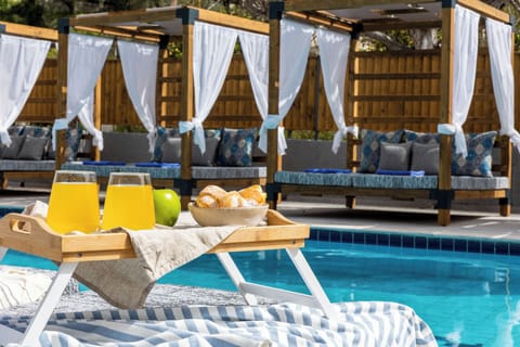 Seasonal outdoor pool, open 8:00 AM to 7:00 PM, pool umbrellas