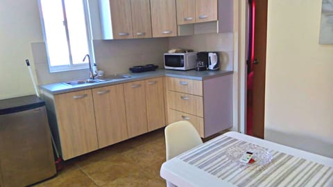 Comfort Apartment | Private kitchen | Fridge, stovetop, electric kettle, toaster