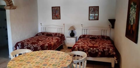 Laptop workspace, iron/ironing board, bed sheets