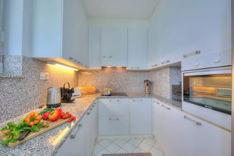Family Apartment, 2 Bedrooms, Refrigerator & Microwave, Mountainside (Residenza Parco Carona) | Private kitchen | Fridge, microwave, oven, stovetop