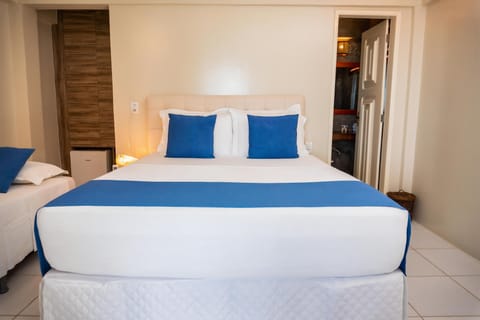 Comfort Triple Room, Pool View | Minibar, individually decorated, individually furnished, bed sheets