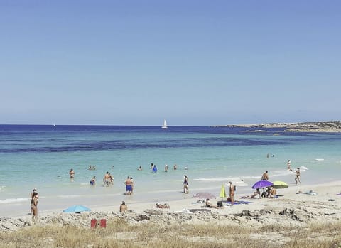 On the beach, white sand, sun loungers, beach umbrellas