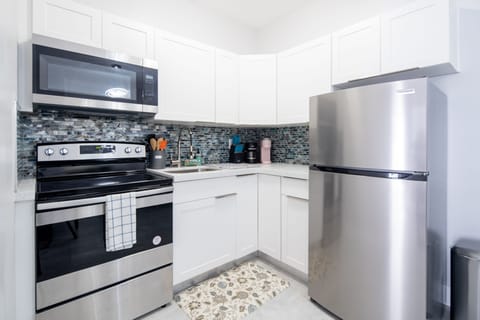 Deluxe Condo | Private kitchen | Full-size fridge, microwave, oven, stovetop