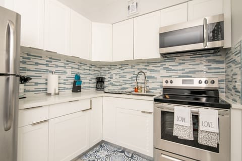 Deluxe Condo | Private kitchen | Full-size fridge, microwave, oven, stovetop