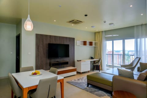 Deluxe Suite, 1 King Bed | Living area | 55-inch LCD TV with cable channels, TV