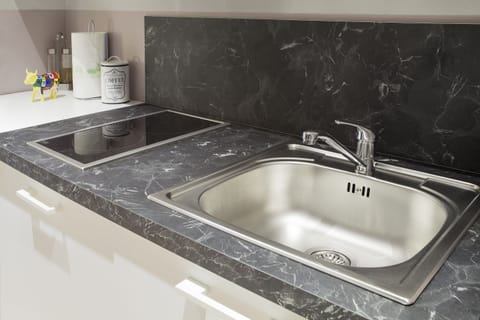 Comfort Apartment, 1 King Bed, Non Smoking, Fireplace | Private kitchen | Microwave, stovetop, dishwasher, highchair