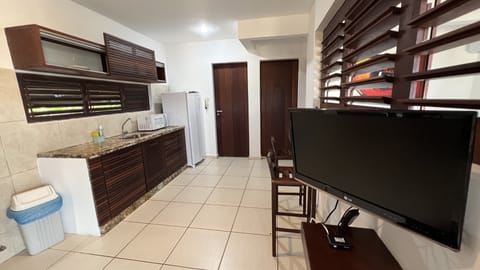 Family Apartment, Pool View | Living area | Flat-screen TV