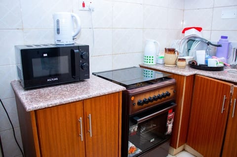 City Apartment, 4 Bedrooms | Private kitchen | Fridge, microwave, cookware/dishes/utensils, dining tables