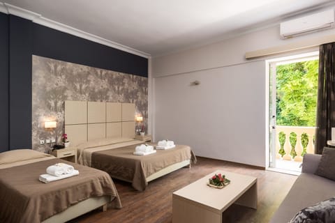 Quadruple Room | Minibar, in-room safe, blackout drapes, iron/ironing board