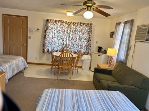 Deluxe Room, 2 Queen Beds, Pool View | Living area | 32-inch flat-screen TV with cable channels, TV