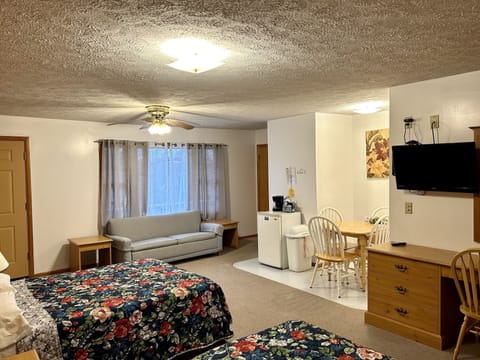 Deluxe Room, 2 Queen Beds, Pool View | Living area | 32-inch flat-screen TV with cable channels, TV