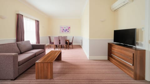 Suite, 1 Bedroom (Dining Area) | In-room safe, desk, laptop workspace, iron/ironing board