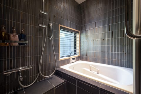 Standard Suite | Bathroom | Separate tub and shower, free toiletries, hair dryer, slippers