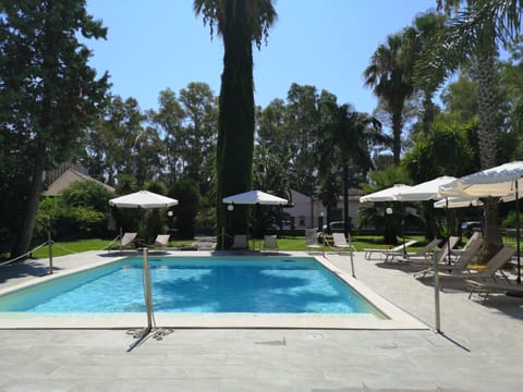 Seasonal outdoor pool, open 9:00 AM to 6:00 PM, pool umbrellas