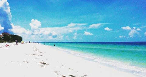 Beach nearby, white sand, beach umbrellas, beach towels