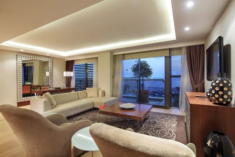 Junior Suite, Partial Sea View | Living room | Flat-screen TV