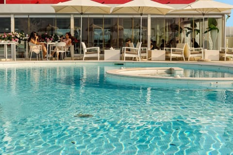 Seasonal outdoor pool, a rooftop pool, pool umbrellas, sun loungers