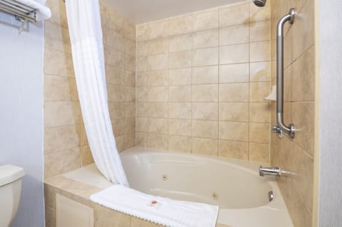 Suite, 1 King Bed, Non Smoking, Jetted Tub (1 Person Jetted Tub) | Bathroom | Combined shower/tub, eco-friendly toiletries, hair dryer, towels